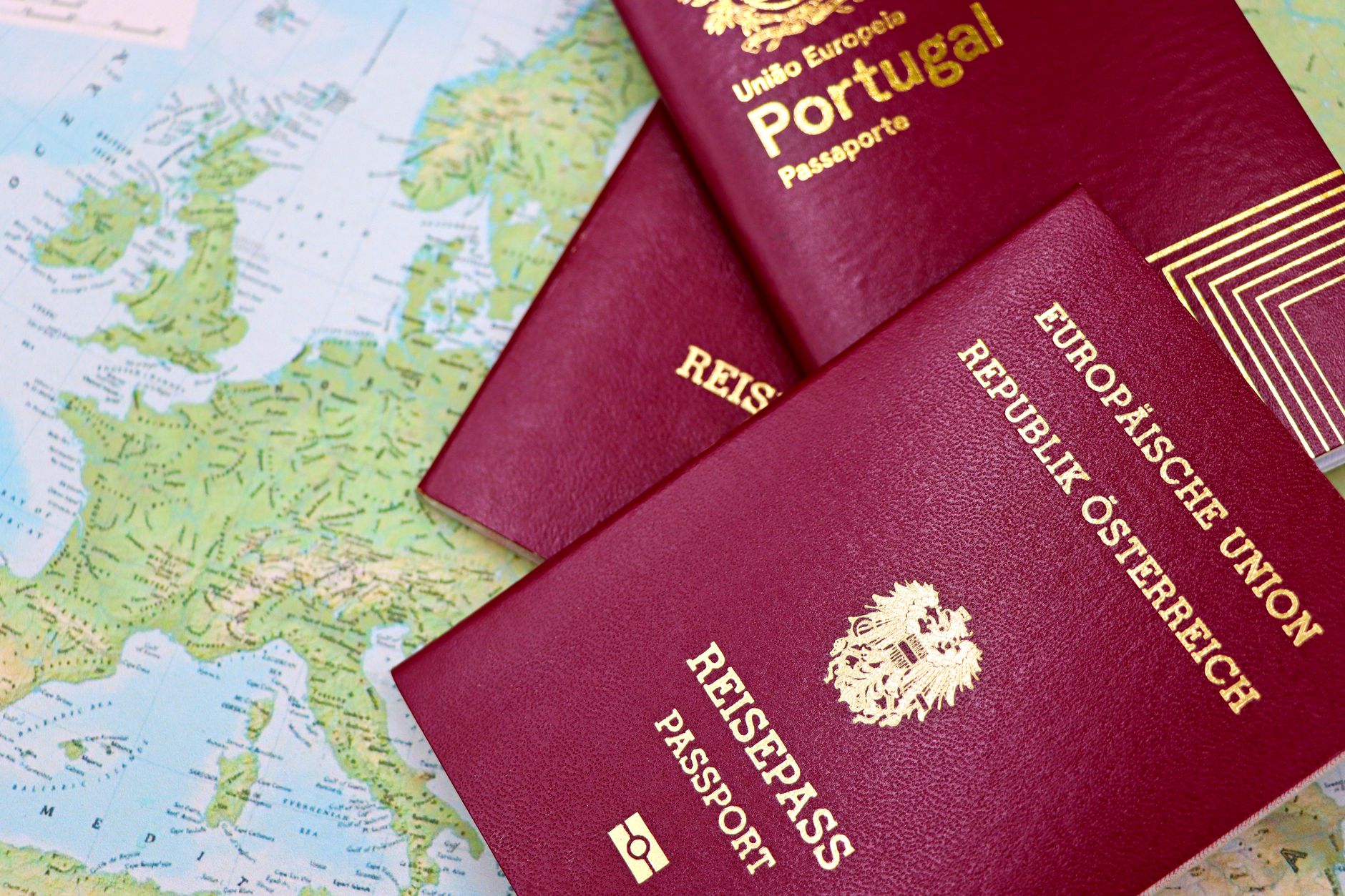 Zbliżenie na paszporty Portugalii i Austrii na mapie świata